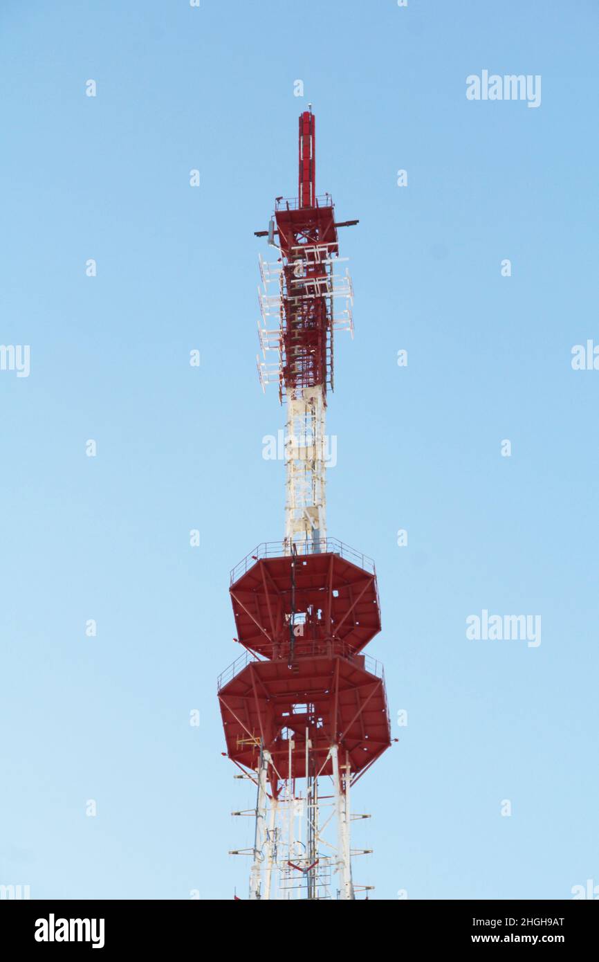 Base station mobile network antenna on a steel structure mast with a repeater. 3g, 4g, 5g. Blue