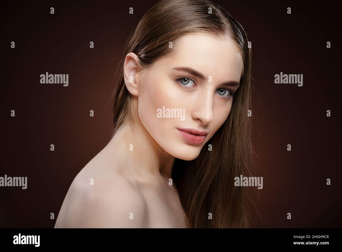 Spa and beautiful concept. Standing half-turned natural beauty woman with no make up face portrait. Healthy pure skin model posing on camera isolated on black background. Natural make up concept.  Stock Photo