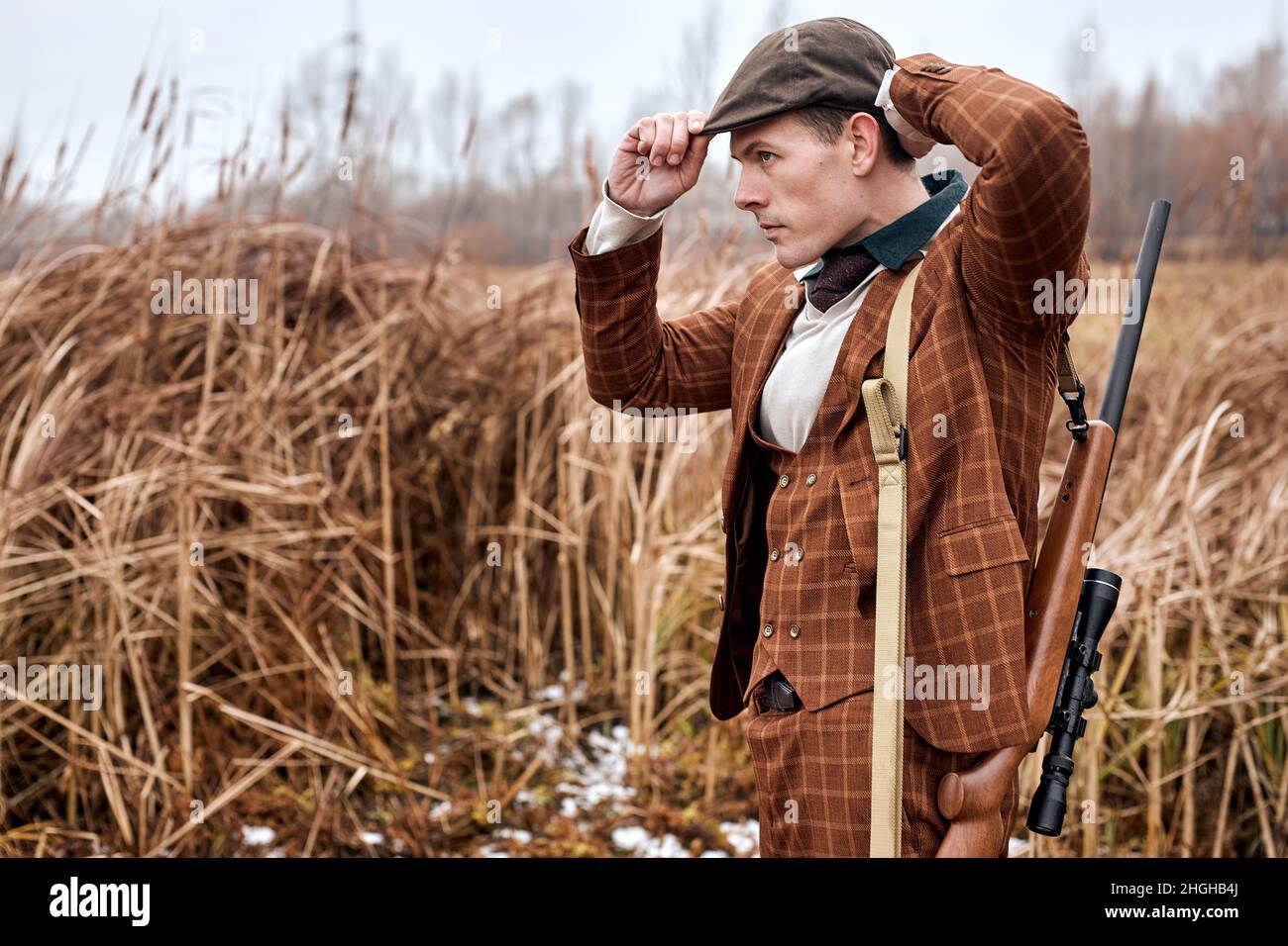 Young caucasian european hunter. American hunting rifles. Hunting without borders. Hunter with shotgun gun on hunt. Portrait of handsome Hunter in bro Stock Photo