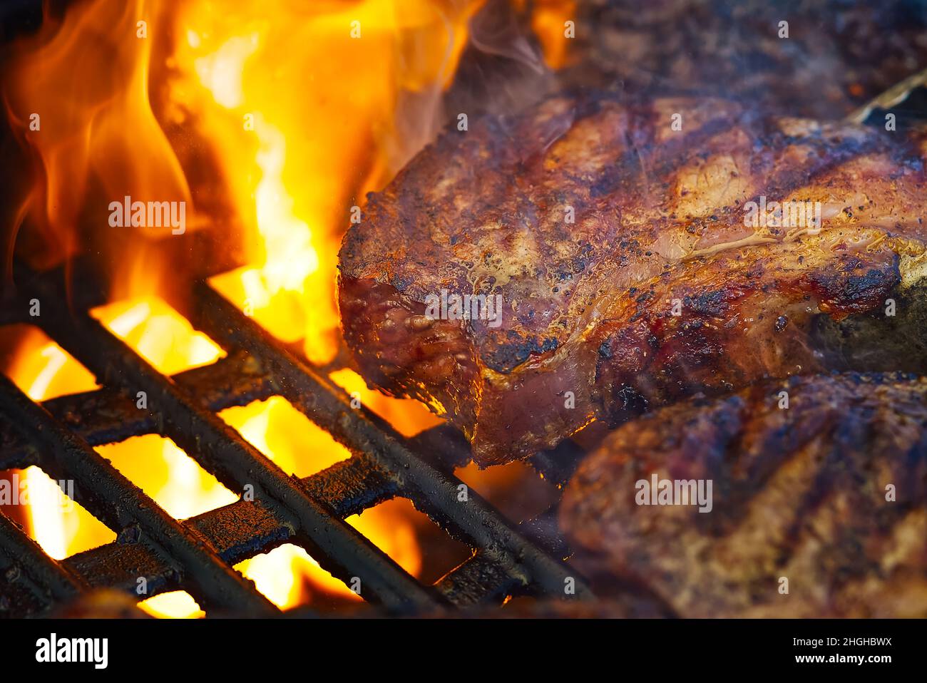 Rib eye steaks grilled outdoors Stock Photo - Alamy