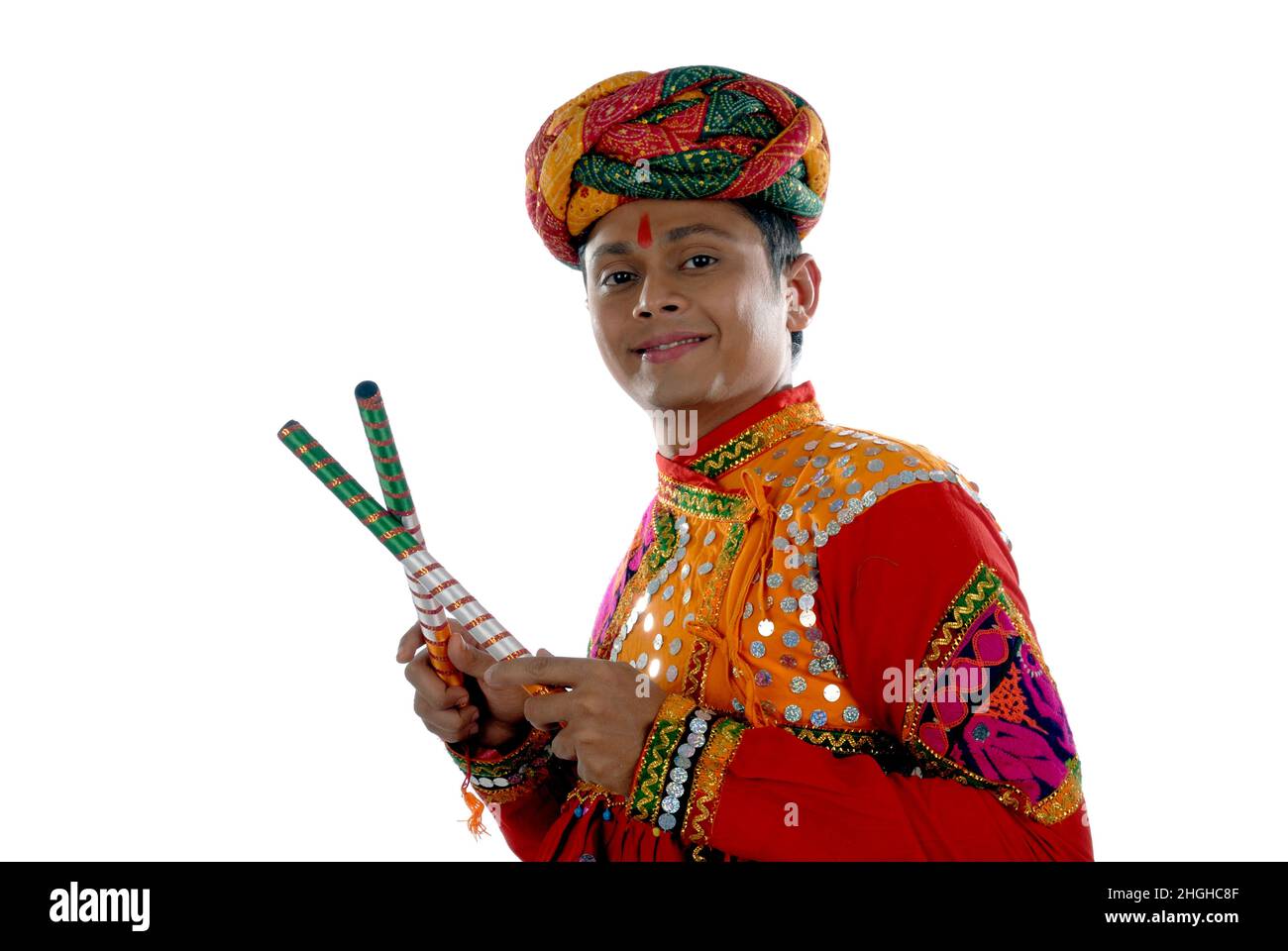 Mumbai Maharashtra India Asia Dec. 26 2009 Rajasthani young Man Playing Dandiya Raas Smiling Wearing Colorful Traditional Dress white Background Stock Photo Alamy