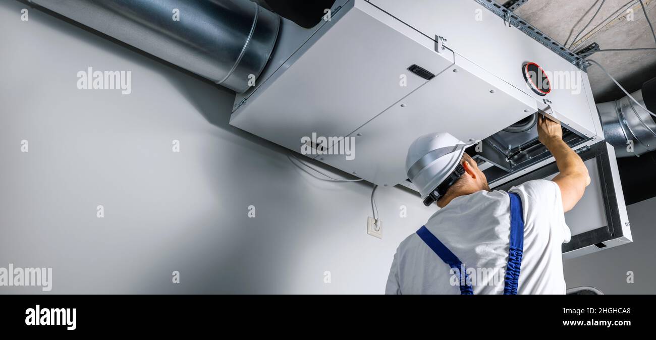 hvac engineer install heat recovery ventilation system for new house. copy space Stock Photo