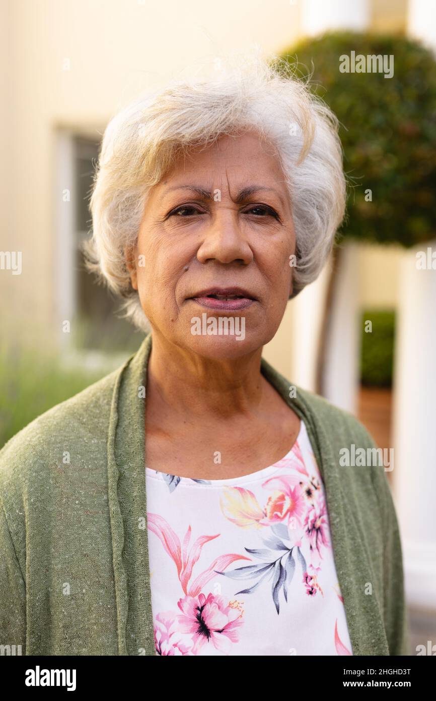 Portrait of senior african american woman with short white hair at backyard Stock Photo