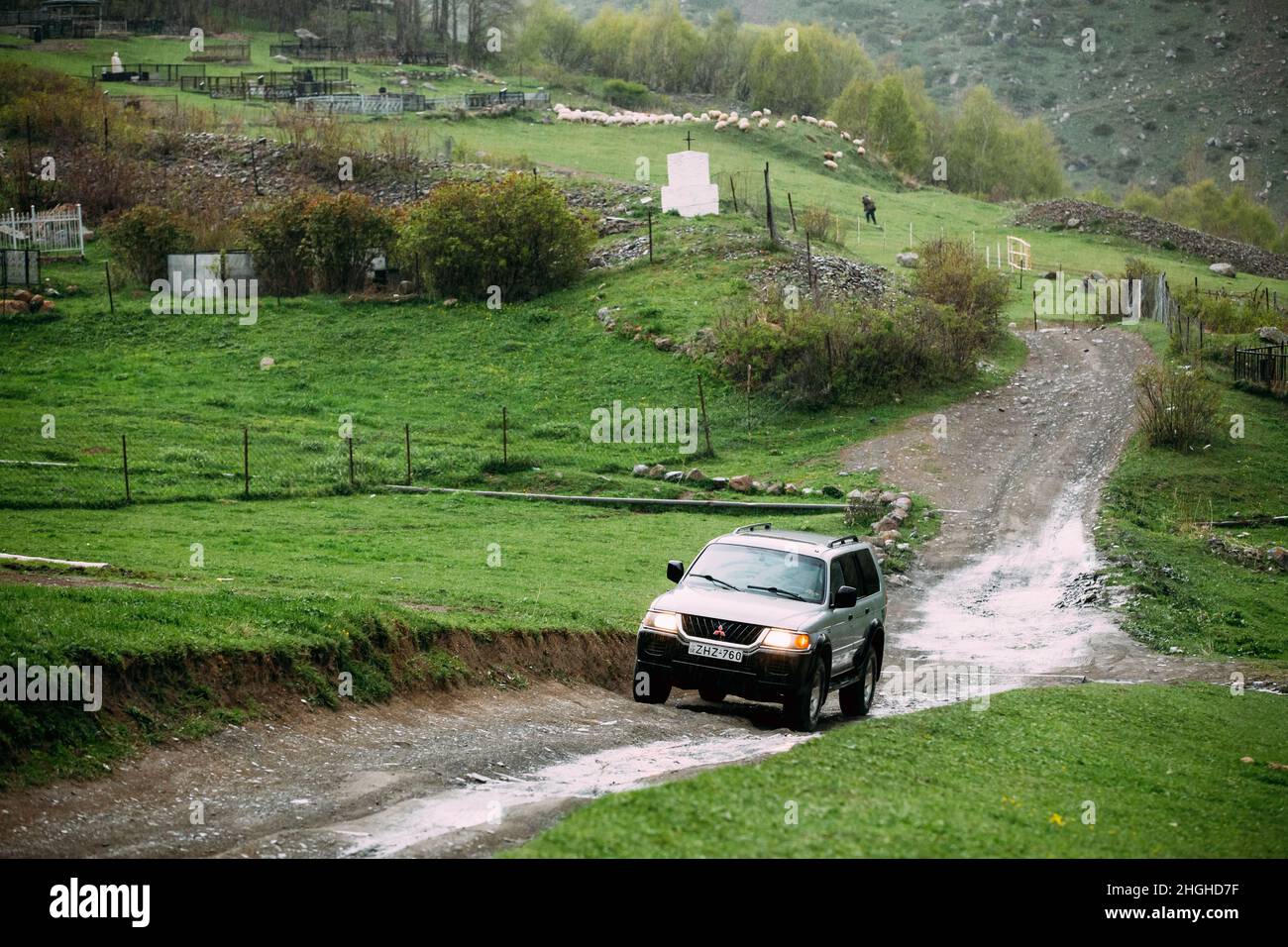 Mitsubishi Montero Sport SUV car driving on off road in summer mountain. Mitsubishi Pajero Sport is a mid-size SUV produced by the Japanese Stock Photo