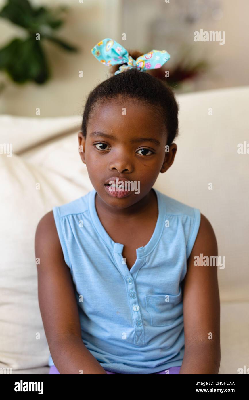 Portrait of african american girl sitting on the couch at home Stock ...