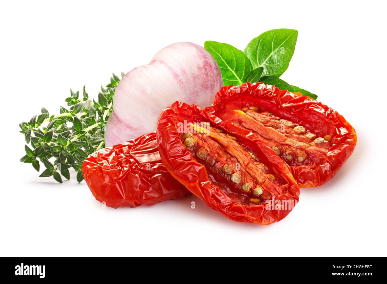 Dried or Sundried tomato halves with herbs and garlic isolated Stock Photo