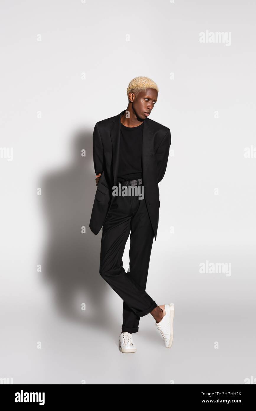 Mens black suit with white sneakers best sale