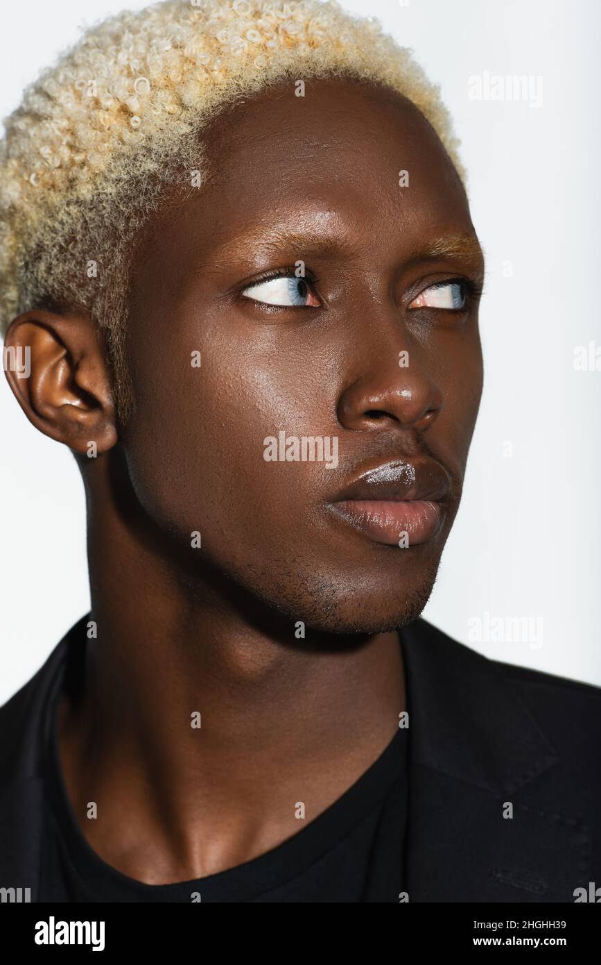 close up portrait of young african american man with blonde hair isolated  on grey Stock Photo - Alamy