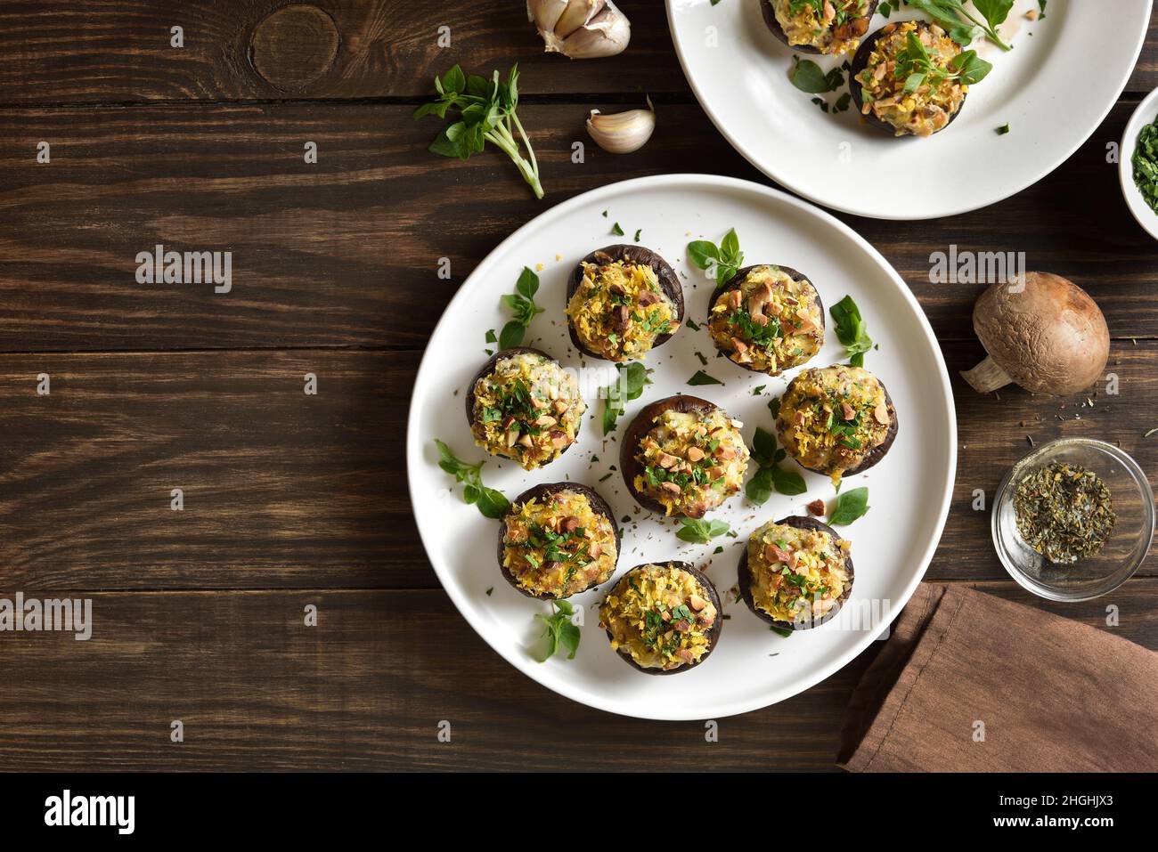 Stuffed mushrooms with cream cheese, bread crumbs and nuts on plate