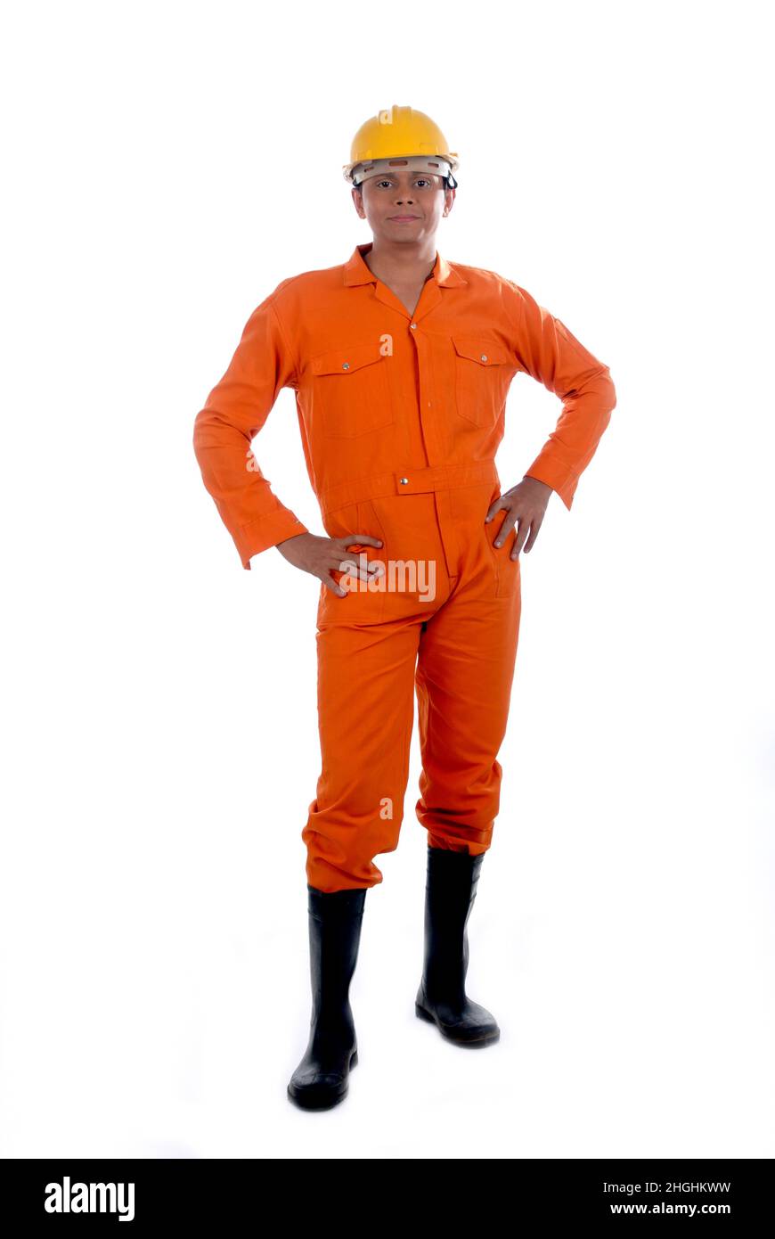 Mumbai; Maharashtra; India- Asia; Dec. 26; 2009 - Happy indian handsome young man worker wearing uniform and helmet, over isolated white background Stock Photo