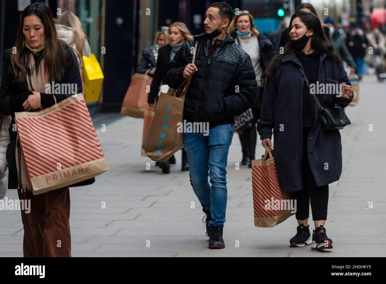 London, UK. 21st Jan, 2022. People with Primark shopping bags in Oxford Street. The retailer has announced that rather than put prices up, 400 mainly retail manager jobs would be lost as the store reacts to rising costs. Credit: Stephen Chung/Alamy Live News Stock Photo