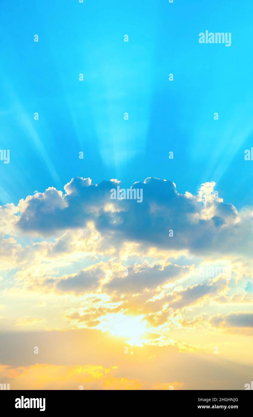 Sunrise sky with sun golden rays breaking through the dark clouds ...