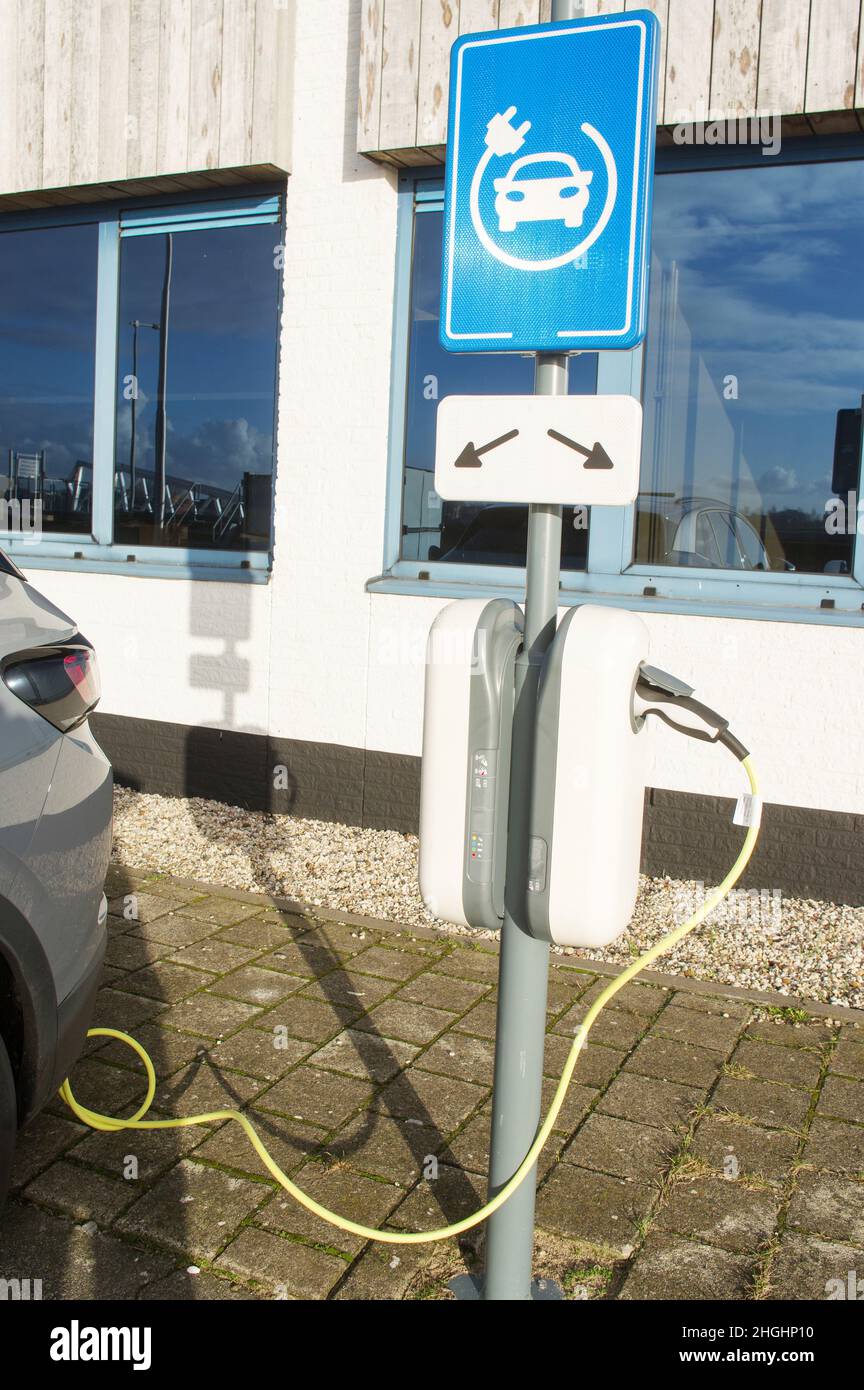 Electric car connected to charge station for charging the battery with
