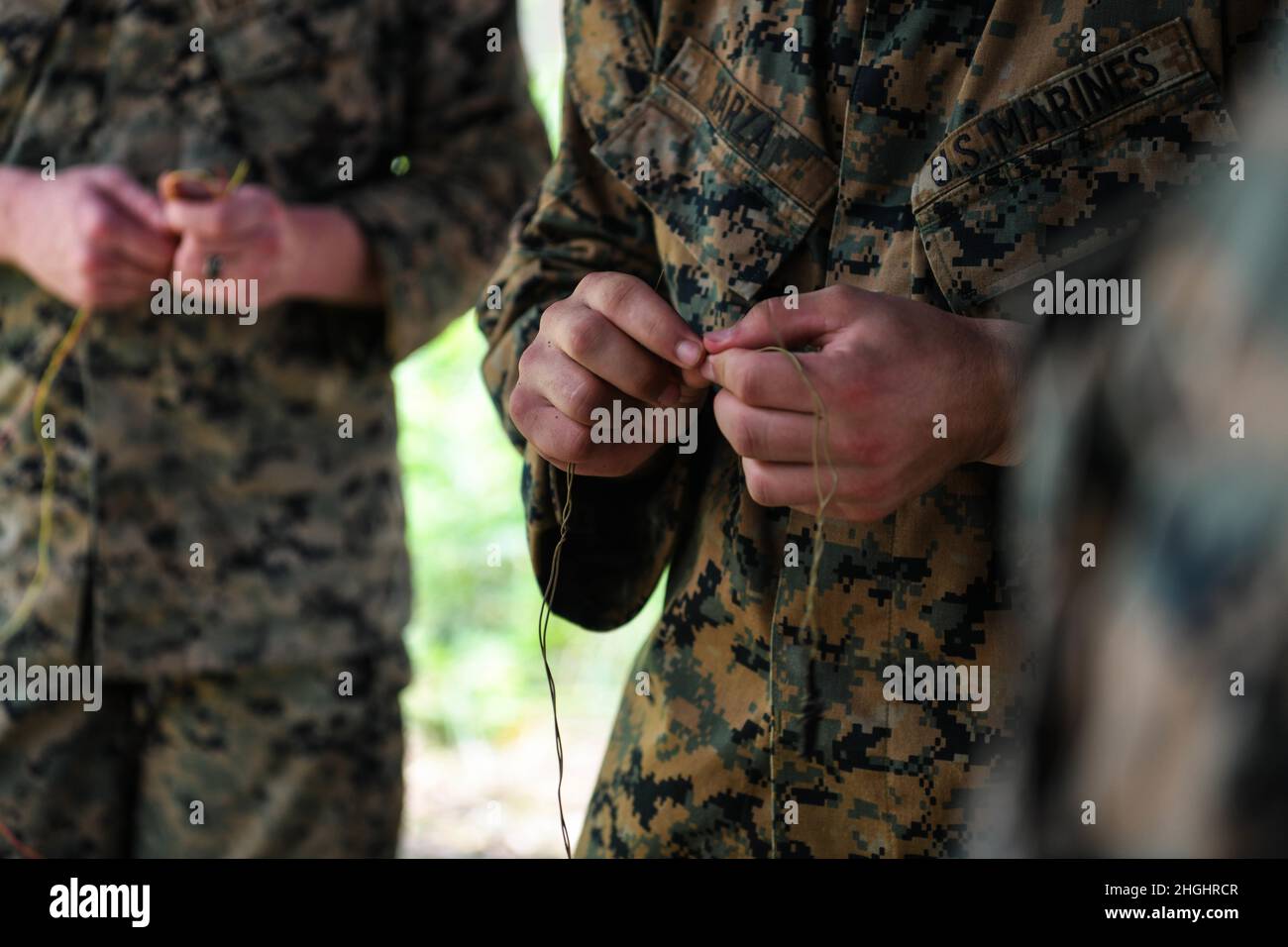 U.S. Marines with Bridge Company, 9th Engineer Support Battalion, 3rd Marine Logistics Group, test wires as part of a Royal Thai Army-led training on how to locate and disarm open-circuit booby-traps during Exercise Cobra Gold 21 at Ta Mor Roi training area in Surin Province, Thailand, Aug. 6, 2021. Royal Thai and American Armed Forces worked together during the exercise to conduct landmine disposal operations, render-safe procedure training, and partnered medical response trauma training. This exercise is aligned with the U.S. Department of Defense’s Humanitarian Mine Action Program, which as Stock Photo