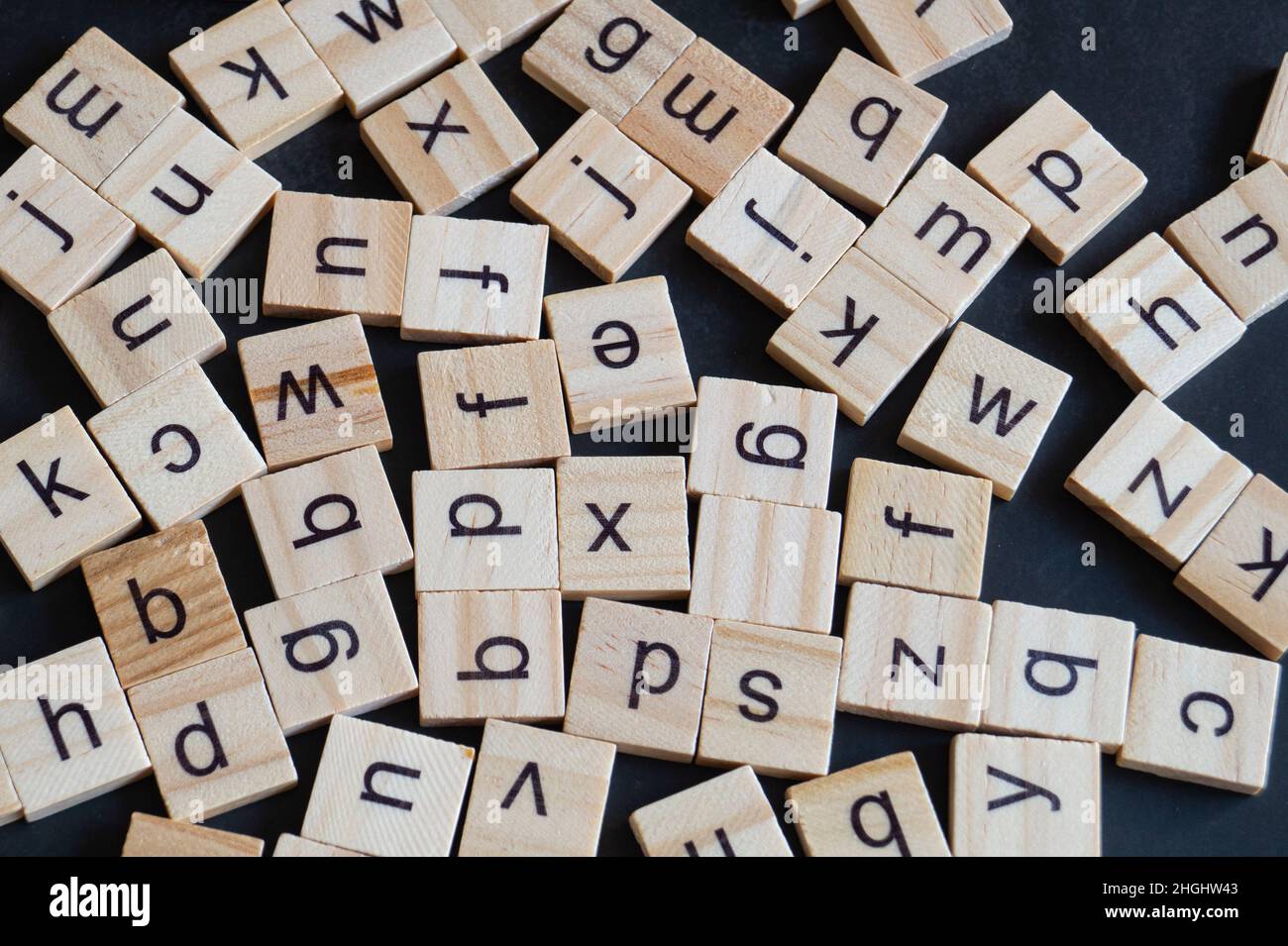 Alphabet letters on wooden scrabble pieces, close up Stock Photo