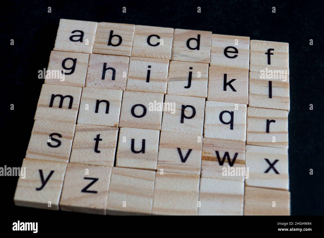 Alphabet letters on wooden scrabble pieces, close up Stock Photo