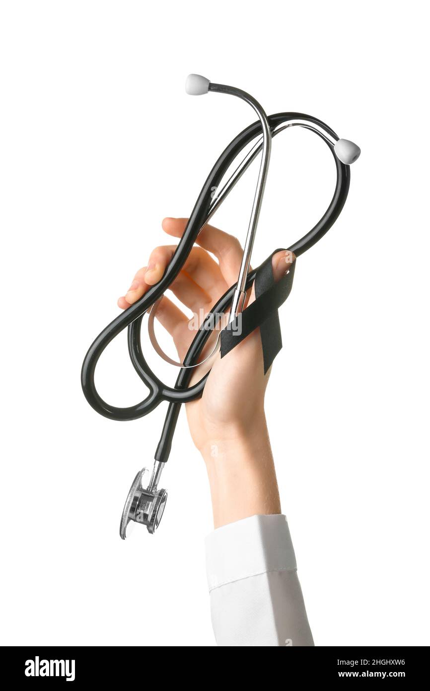 Female hand with black ribbon and stethoscope on white background ...