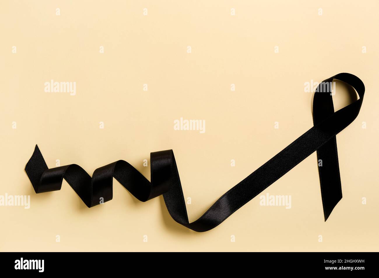Black satin ribbon on color background. Melanoma concept Stock Photo ...