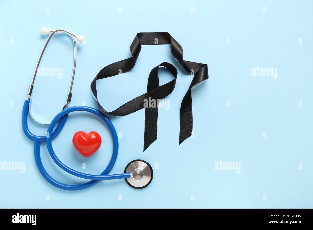 Black ribbon, stethoscope and heart on blue background. Melanoma ...