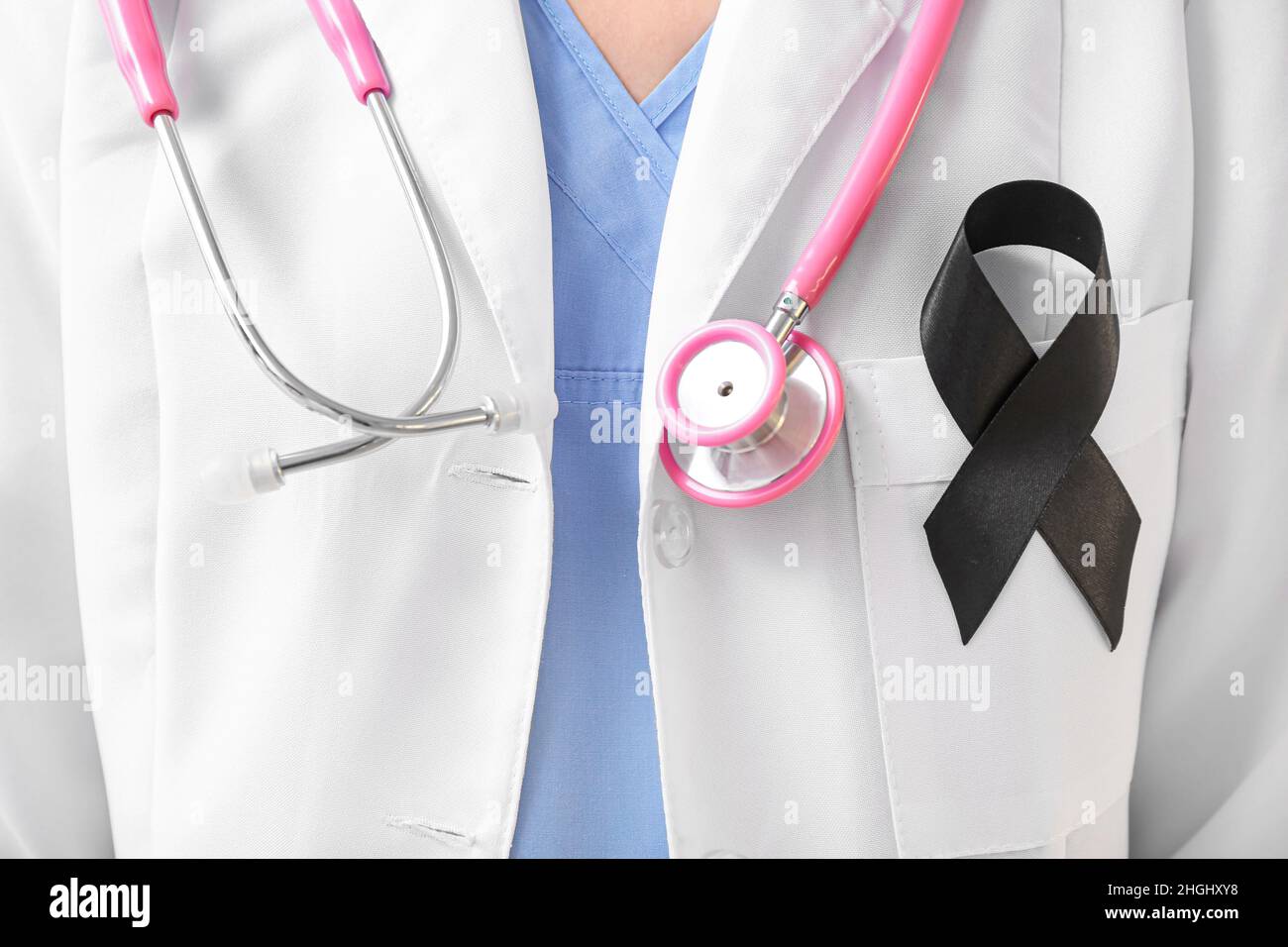 Doctor with black ribbon and stethoscope, closeup. Melanoma concept ...