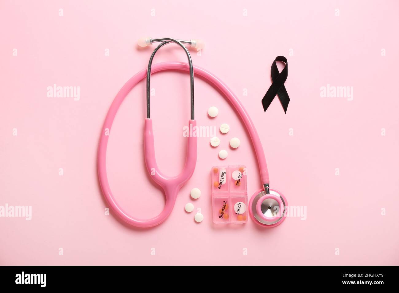 Black ribbon, stethoscope and pills on pink background. Melanoma ...