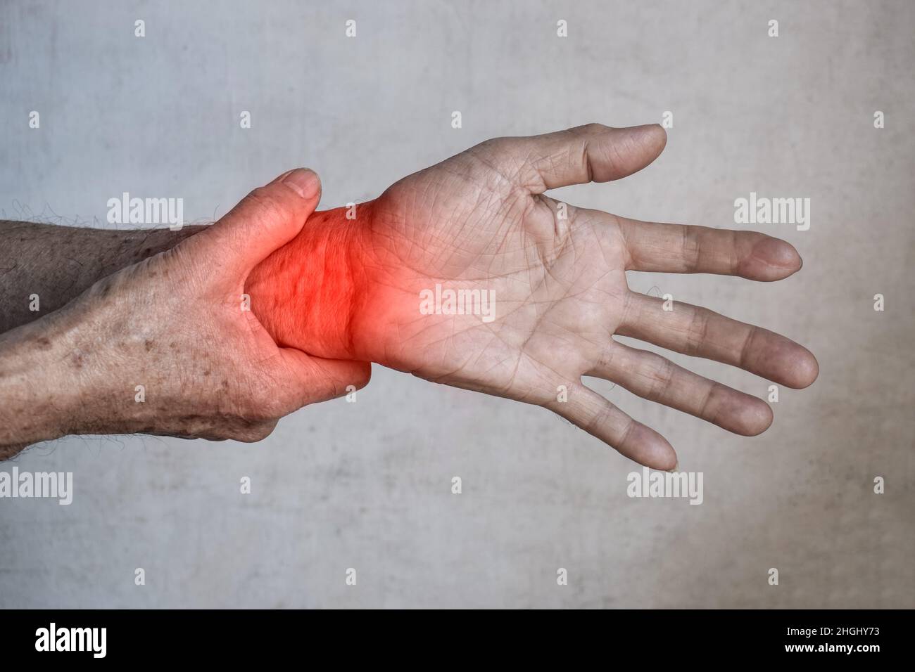 Pain in the wrist joint of Southeast Asian elder man. Concept of hand