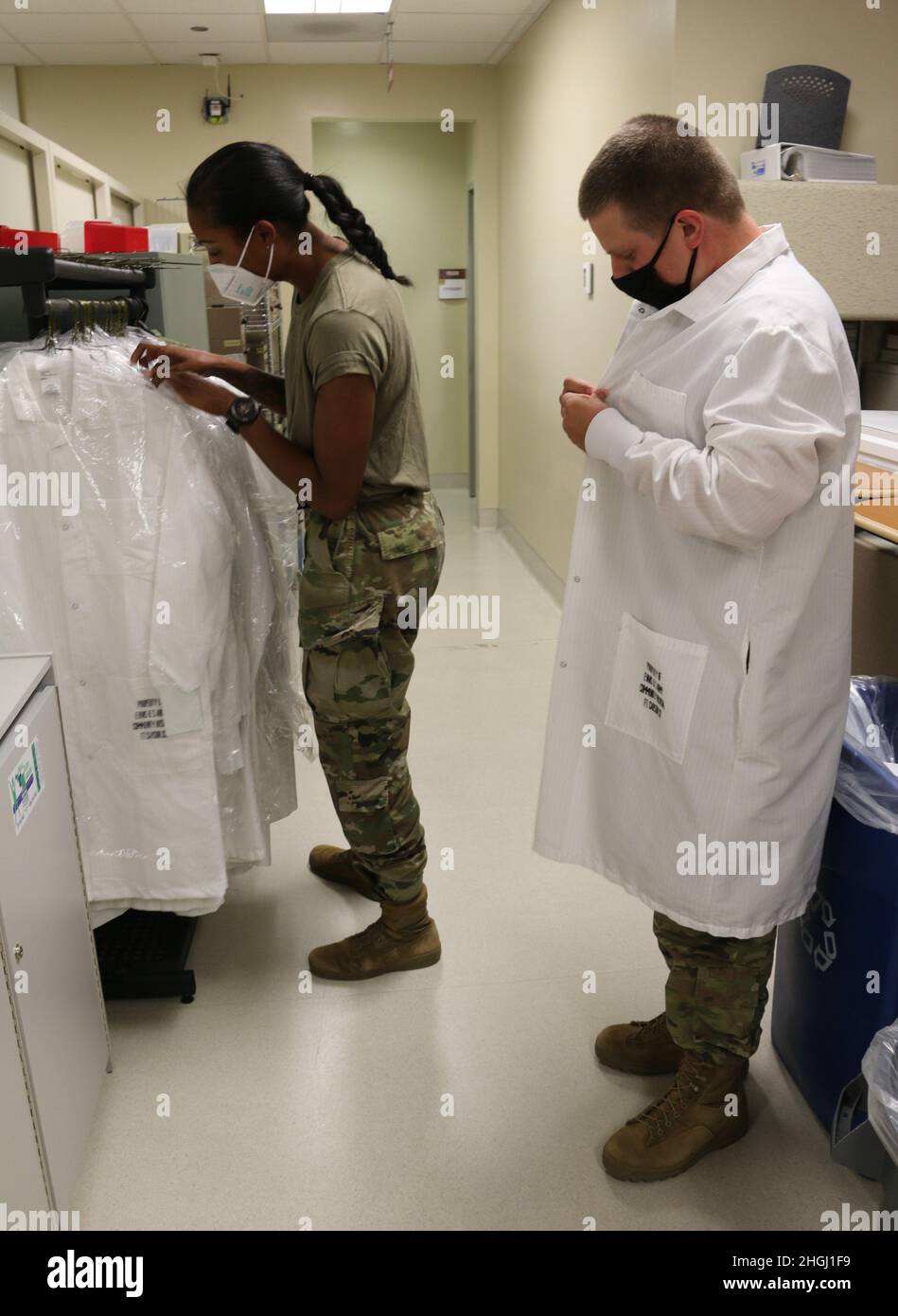 Spc. Kershia Mukoro (left) and Spc. Eric Thompson (right), two medical laboratory specialists from the 7450th Medical Operations Readiness Unit (MORU), start their shift at the Evans Army Community Hospital Laboratory for their U.S. Army Reserve Annual Training Mobilization Exercise Aug. 10, 2021. Stock Photo