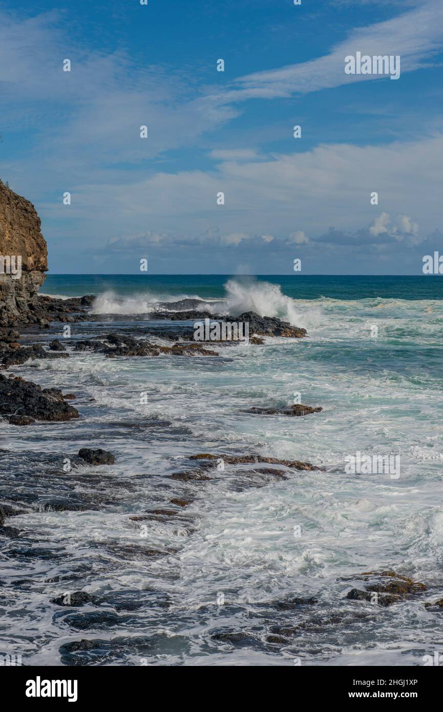 Heavy surf is breaking on the rocks at Mokolea Point, Kilauea Bay, located near Kilauea, Kauai, Hawaii, USA. Stock Photo