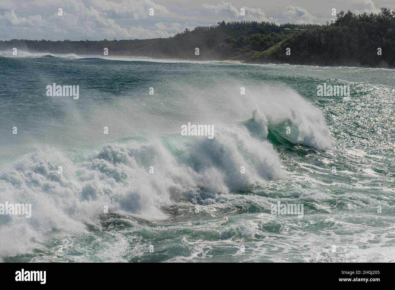 Surf is rolling into Kilauea Bay, located near Kilauea, Kauai, Hawaii, USA. Stock Photo