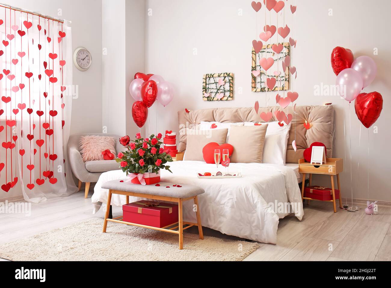 Interior of beautiful bedroom with roses, glasses of champagne and ...