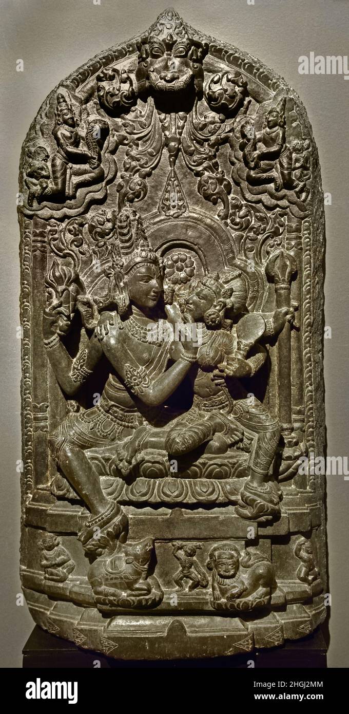 Uma Maheshvara ( Shiva and Parvati with their respective vehicle, the bull and the lion, at their feet North East India 10th - 11th century A.D., Indian, Basalt Stock Photo
