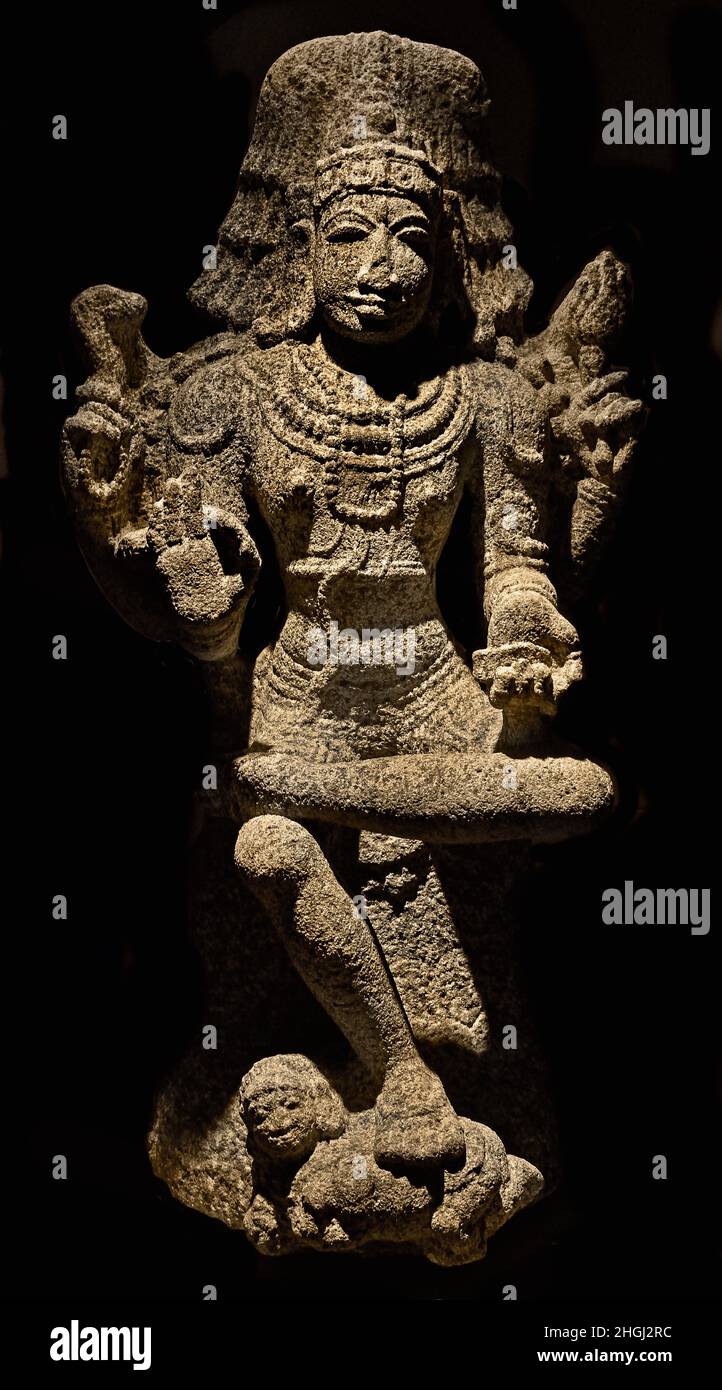 Dakshinamurti - The God Shiva as supreme teacher of Knowledge, arts and yoga. His Image faces South - Tamil Nadu 12th century A.D South, India, Indian, Grey Granite. Stock Photo