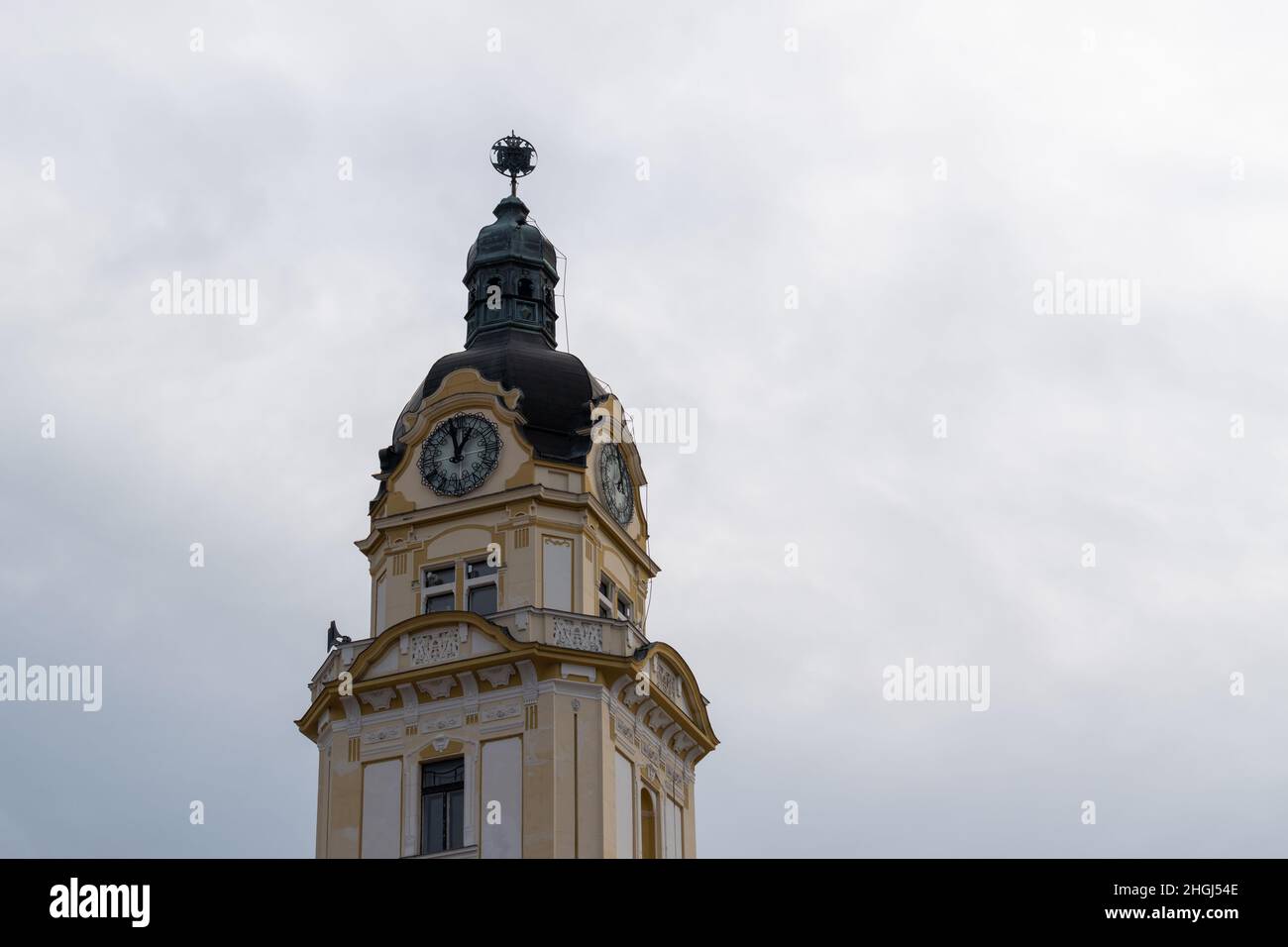 Clock tower with beautiful ornamental facade, detail from city assembly building in city of Pecs, Hungary Stock Photo