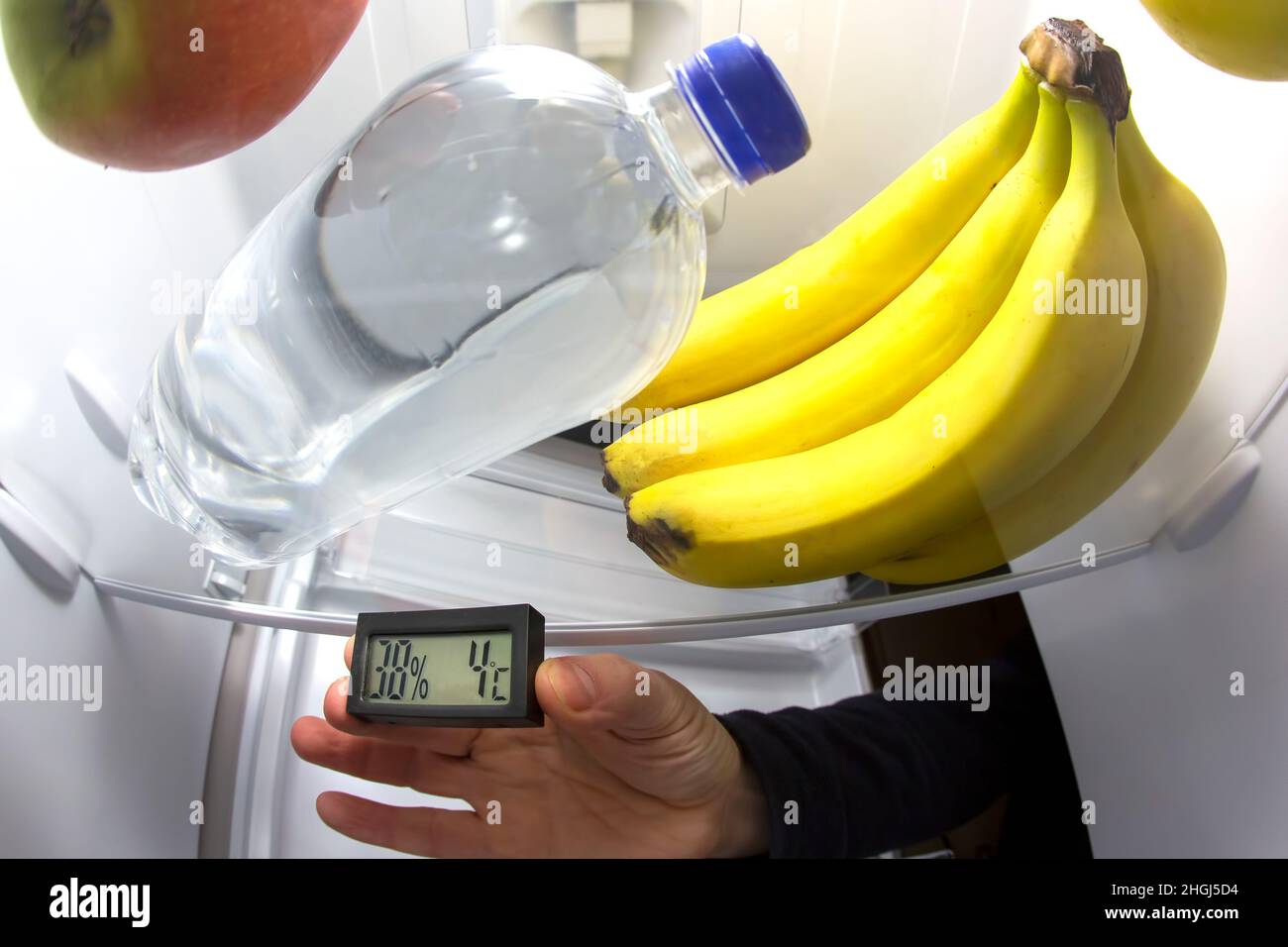thermometer for measuring the temperature in the refrigerator inside among the products Stock Photo