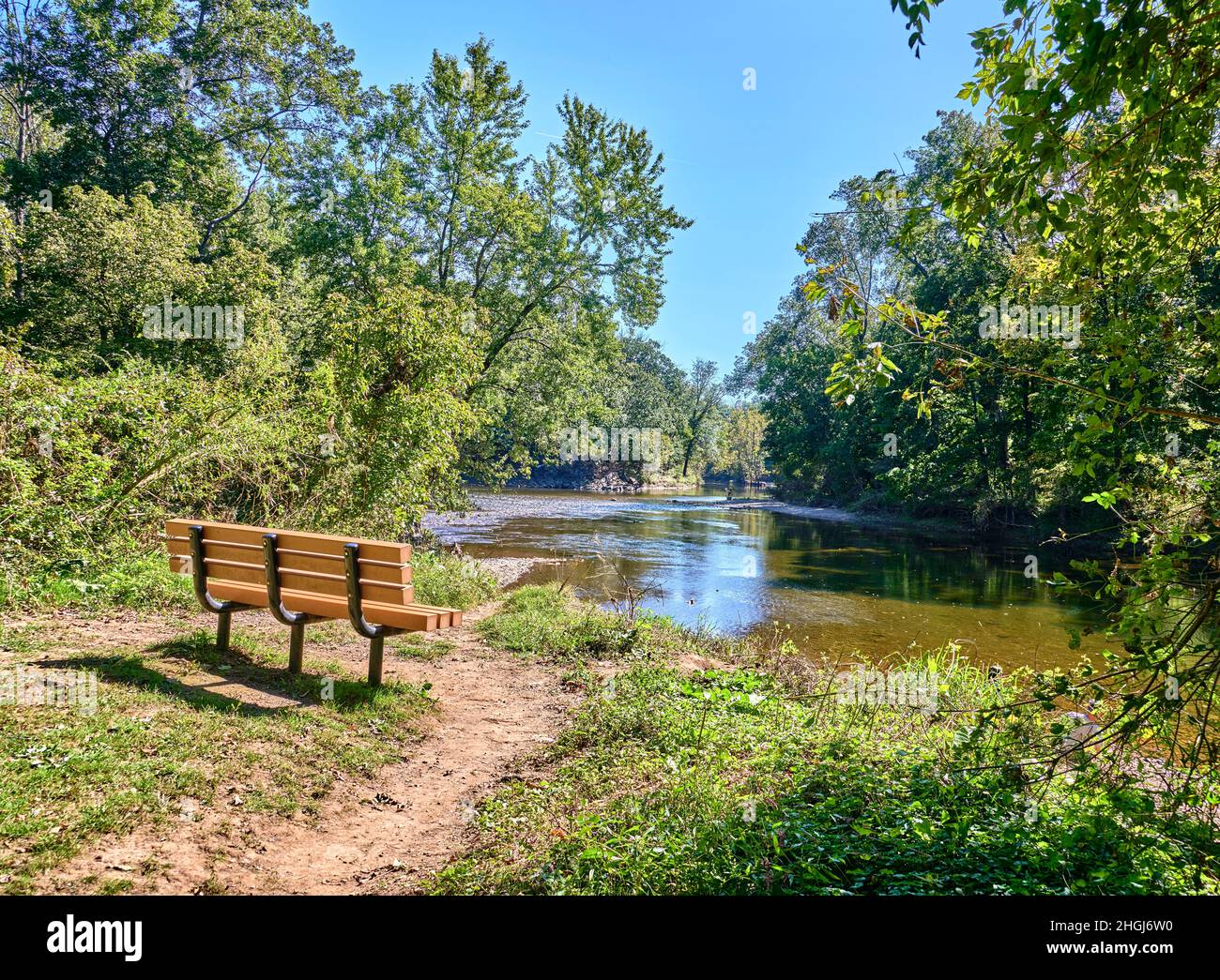 Empty Park bench overlooking a lake,pond called Neshaminy Creek in