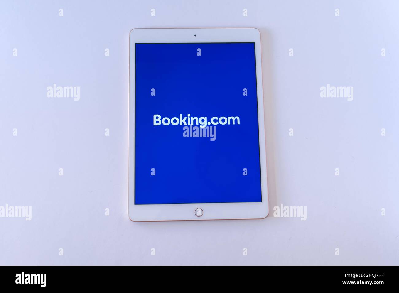Barcelona, 2022: Tablet with Booking.com logo on an empty background. Travel and technology. Copy space Stock Photo