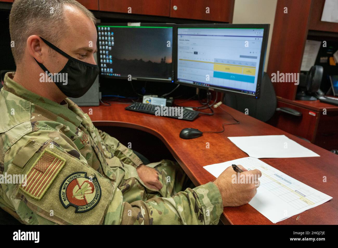Master Sgt. Nathan Horrocks, 314th Aircraft Maintenance Squadron section chief, navigates the Torque personnel management system and goes through a printed schedule at Little Rock Air Force Base, Arkansas, Aug. 13, 2021. The Torque system allows section chiefs to oversee appointments, manning, and qualifications of all maintainers within one system. Stock Photo