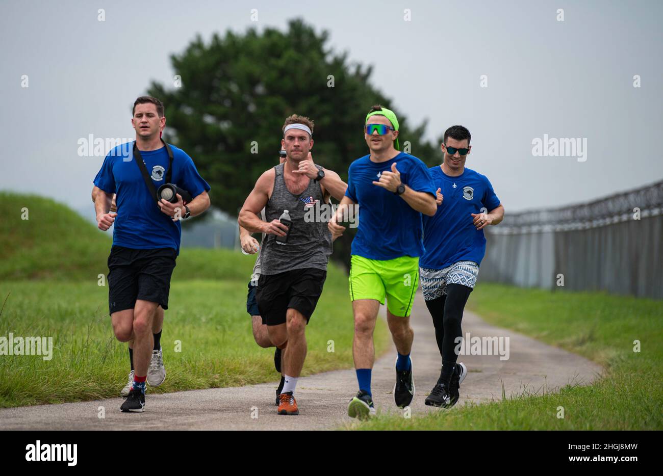 Airmen run to celebrate the life and legacy of Capt. William “Pyro” DuBois, F-16 fighter pilot, during Pyro’s “Push It Up” Trail Run at Kunsan Air Base, Republic of Korea, Aug. 14, 2021. For the last seven years, friends, family and fellow Airmen have organized trail runs in his honor every Aug. 14th, DuBois birthday. In keeping with tradition, the runs vary in length from 3.5k, 7.7k or 13k distances. Stock Photo