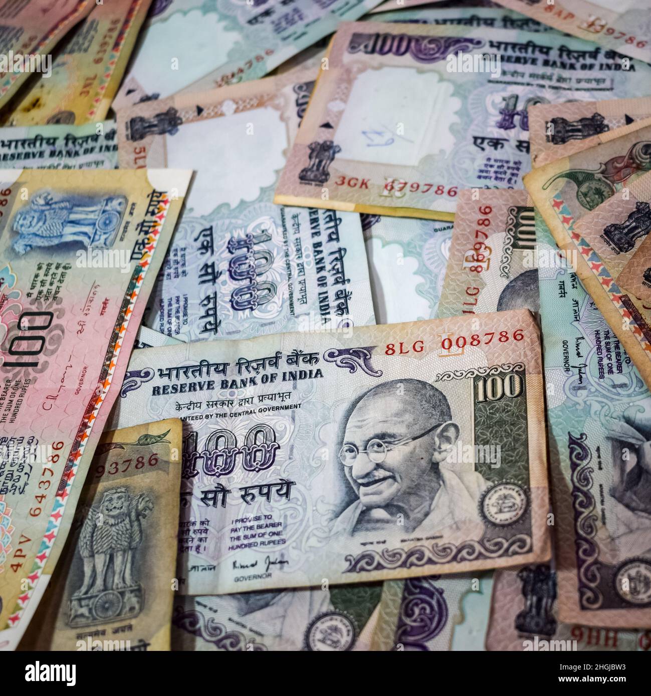 Old One Hundred Rupee notes combined on the table, India money on the rotating table. Old Indian Currency notes on a rotating table, Indian Currency o Stock Photo