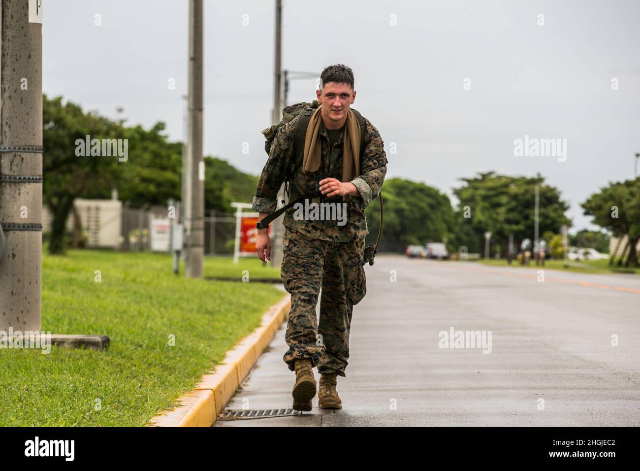 A U.S. Marine with 9th Engineer Support Battalion, 3d Marine Logistics Group, participates in a timed ruck run during a Littoral Engineer Reconnaissance Team screener on Camp Hansen, Okinawa, Japan, Aug. 18, 2021. 9th ESB conducted the screener to select the most qualified Marines and Sailors to serve on the Littoral Engineer Reconnaissance Team, and to introduce some of the physical and mental challenges that LERT Marines will be expected to overcome. The LERT is a 3d MLG capability, specialized in engineering and mobility-specific intelligence reconnaissance in support of the battalion comma Stock Photo