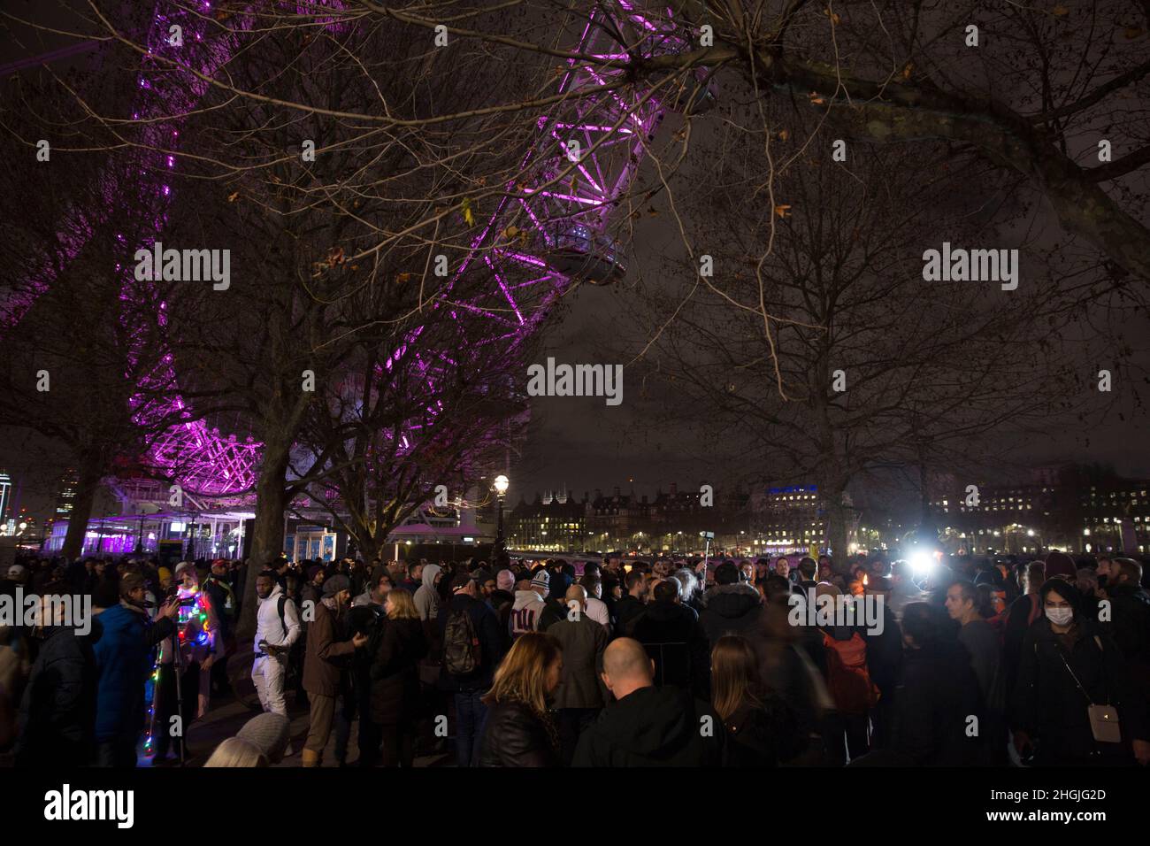 Participants gather for a freedom rally against Covid-related measures such as vaccine passports near London Eye in London on News Year’s Eve. Stock Photo