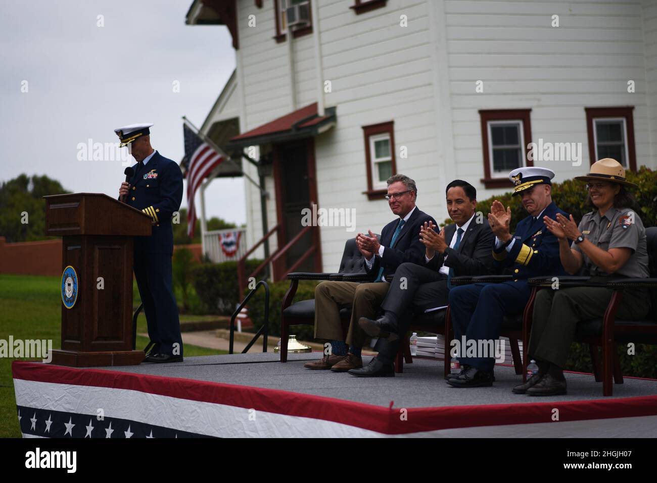 Capt. Timothy J. Barelli, Commanding Officer of U.S. Coast Guard Sector San Diego, speaks while the official party claps during the rededication ceremony at the New Point Loma Lighthouse in San Diego, August 20, 2021. The rededication is the official recognition of the light station's service career and honors its history as a Coast Guard navigational aid. Stock Photo