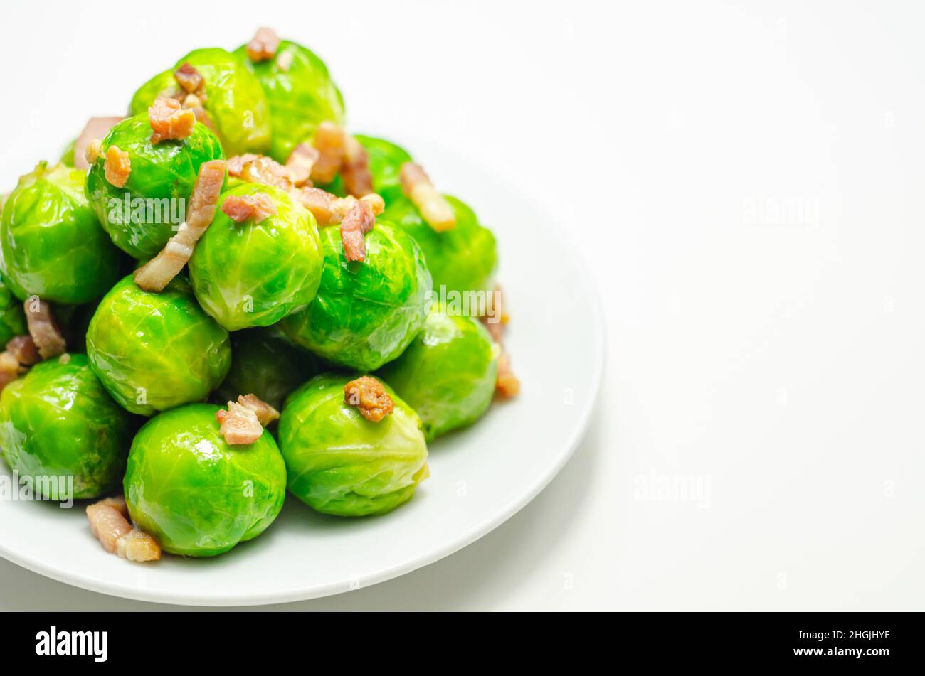 Tasty brussels sprouts with smoked bacon lardons and salted butter