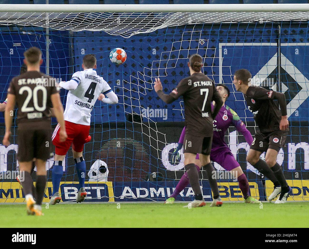 Hamburg, Germany. 21st Jan, 2022. Soccer, 2nd Bundesliga, Matchday 20, Hamburger SV - FC St. Pauli, Volksparkstadion: Hamburg defender Sebastian Schonlau (2nd from left) scores to make it 1:1. IMPORTANT NOTICE: In accordance with the requirements of the DFL Deutsche Fußball Liga and the DFB Deutscher Fußball-Bund, it is prohibited to exploit or have exploited photographs taken in the stadium and/or of the match in the form of sequence pictures and/or video-like photo series. Credit: Christian Charisius/dpa/Alamy Live News Stock Photo