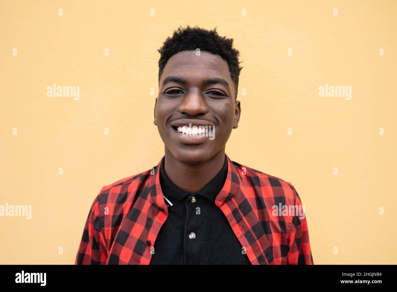 Portrait of happy young African teenager smiling in front of camera Stock Photo