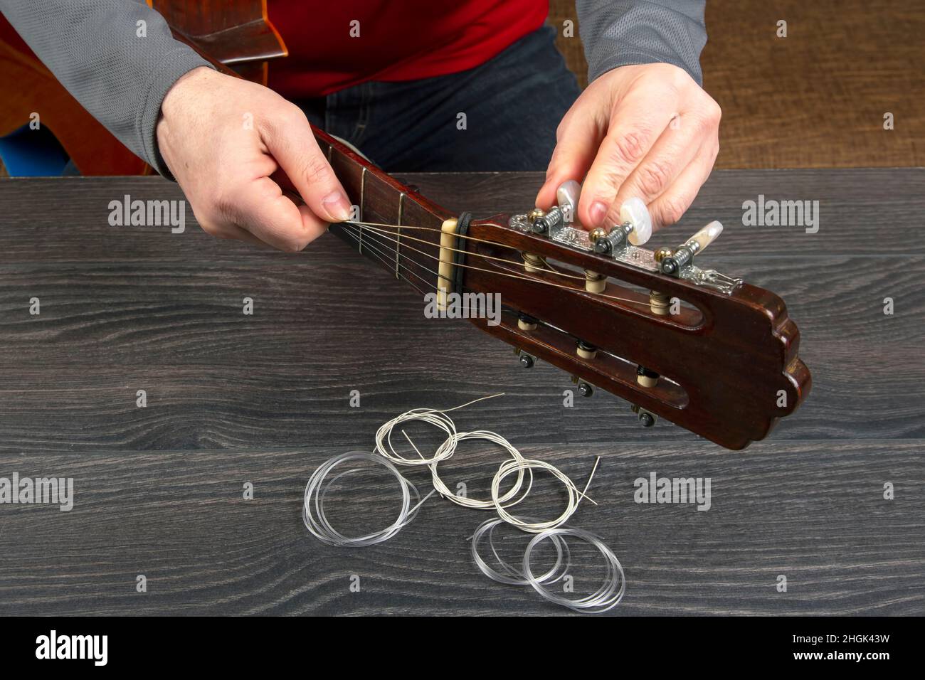 replacement and insertion of nylon strings in a classical guitar