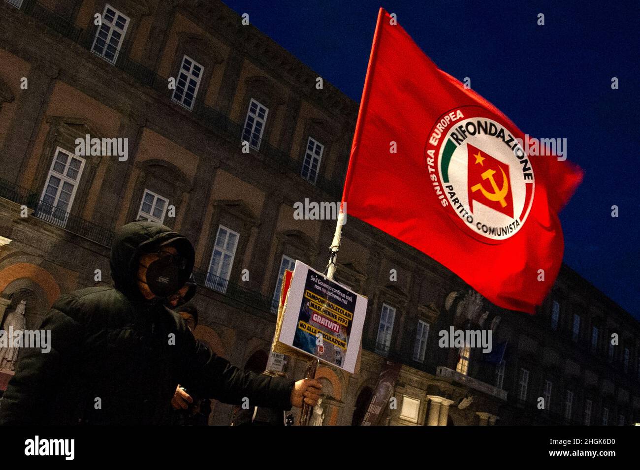 Naples, Italy. 21st Jan, 2022. Protester holds the flag for the communist party in plebiscite square during the demonstration by citizens for the new coronavirus laws. Credit: Vincenzo Izzo/Alamy Live News Credit: Vincenzo Izzo/Alamy Live News Stock Photo