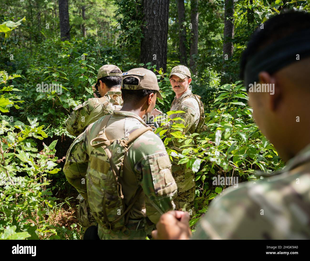 Airmen from the 2nd Security Forces Squadron navigate the east reservation wilderness at Barksdale Air Force Base, Louisiana, Aug. 30, 2021. Land navigation is a core military discipline, involving the use of maps with reference to terrain, a compass and other vital navigation tools. Stock Photo