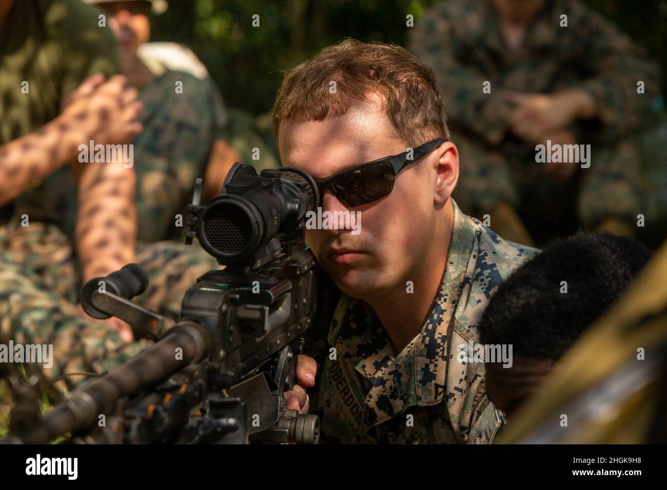 U.S. Marine Lance Cpl. Davis Oberdorf, an infantry machine gunner with 2nd Battalion, 3rd Marine Regiment, 3rd Marine Division, gives an informational brief on the operation of a M240B machine gun during a land warfare training on Camp Schwab, Okinawa, Japan, Aug. 30, 2021. The training consisted of multiple events in which combat, tactics and planning skills were utilized in order to enhance the Marines’ overall warfighting capabilities. Stock Photo