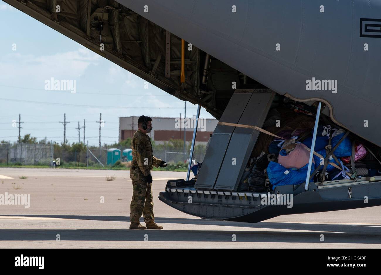 An Airman assigned to Task Force - Holloman prepares to unload luggage in support of Operation Allies Welcome, Aug. 31, 2021, on Holloman Air Force Base, New Mexico. The Department of Defense, through U.S. Northern Command, and in support of the Department of Homeland Security, is providing transportation, temporary housing, medical screening, and general support for up to 50,000 Afghan evacuees at suitable facilities, in permanent or temporary structures, as quickly as possible. This initiative provides Afghan personnel essential support at secure locations outside Afghanistan. Stock Photo